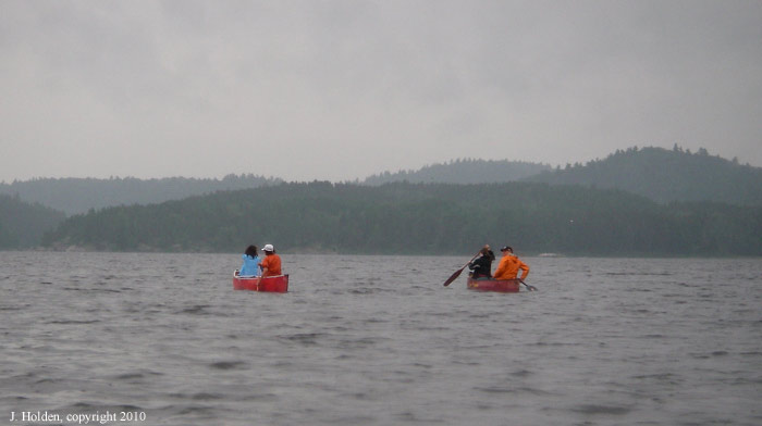 Canoeists setting out in the rain, Algonquin Park